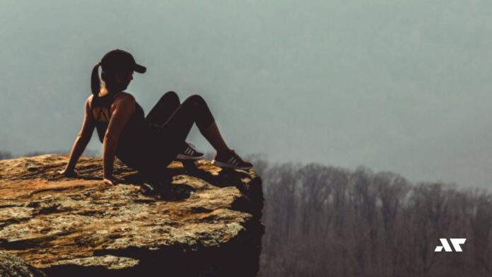Kobieta siedząca na krawędzi skały