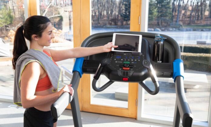 Orbitrek vs bieżnia odchudzanie – kobieta korzystająca z bieżni Horizon podczas treningu